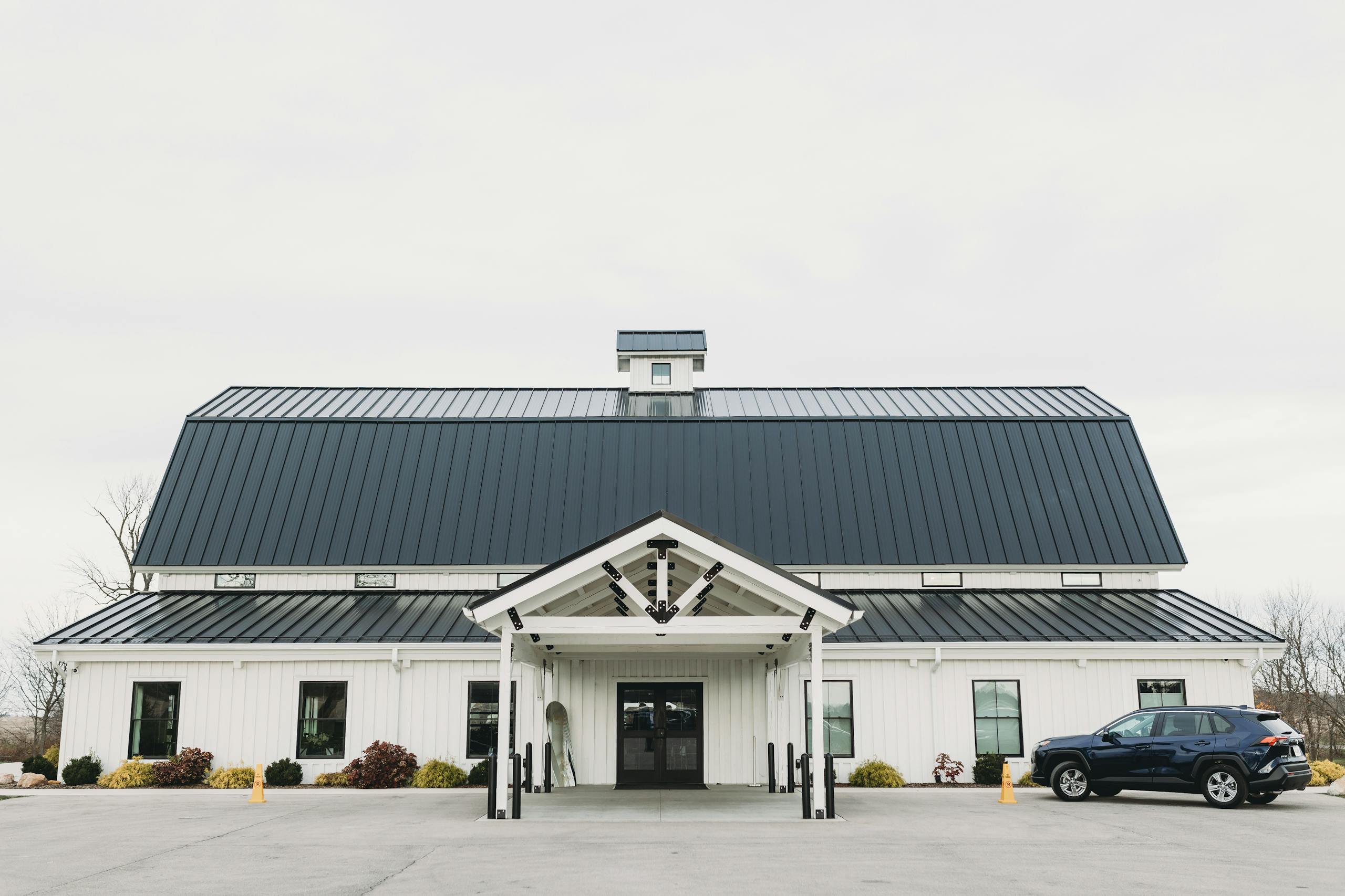 Elegant white barn venue perfect for weddings and events, featuring a modern design.